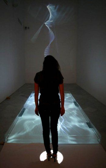 Electronic Shadow/A woman stands next to French artists Naziha Mestaoui and Yacine Aitkaci's art work