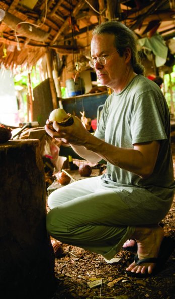 Ted Muehling looks at ivory palm nuts in a carving hut on the Micronesian island of Pohnpei_Ami Vitale